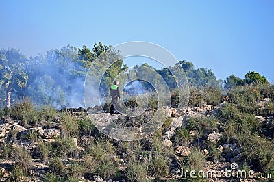 A Policeman Dealing With A Shrubland Fire Editorial Stock Photo