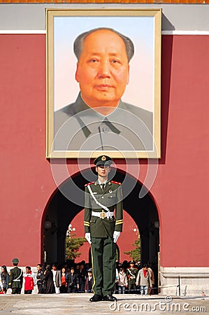 Policeman and Mao's portrait Editorial Stock Photo