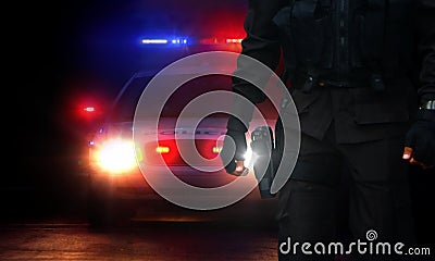 Policeman and patrol car with siren lights on Stock Photo