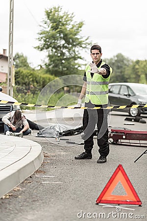 Policeman at road accident scene Stock Photo