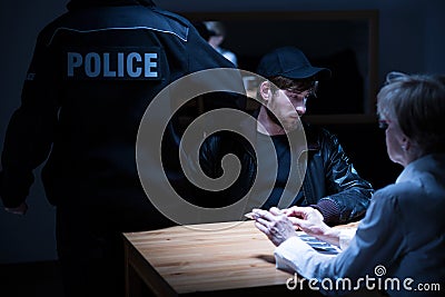 Policeman, suspect and female agent Stock Photo