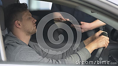 Policeman writing traffic ticket to upset male driver, moving violation, law Stock Photo