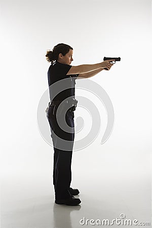 Policewoman aiming gun. Stock Photo