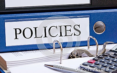 Policies - blue binder with text in the office Stock Photo