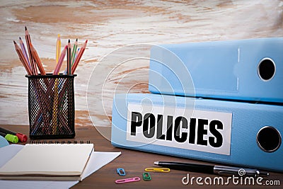 Policies, Office Binder on Wooden Desk. On the table colored pen Stock Photo