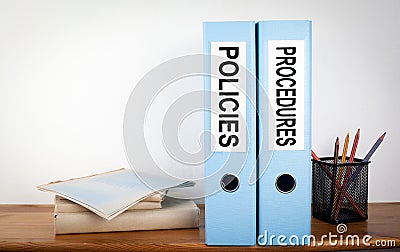 Policies and Procedures binders in the office. Stationery on a wooden shelf Stock Photo