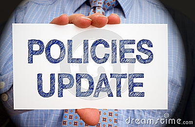 Policies Update - Manager holding sign with text Stock Photo
