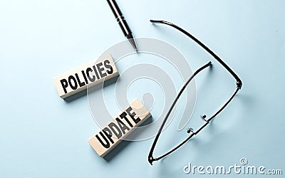 POLICIES UPDATE text on the wooden block ,blue background Stock Photo