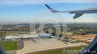 LOT Polish airlines aircraft over Cargo terminal in Chopin airport. Editorial Stock Photo