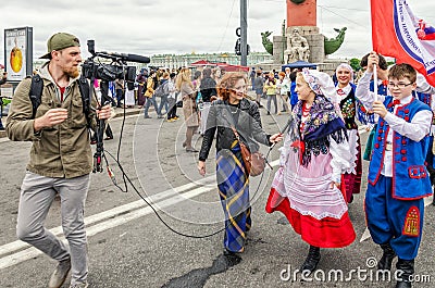 Polish folk dance ensemble GAIK are passing to the point of the performance. Giving interview on the go. Editorial Stock Photo