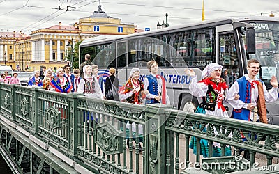 Polish folk dance ensemble GAIK are passing to the point of the performance over the Dvortsoviy bridge. Editorial Stock Photo