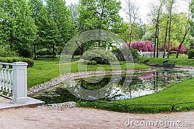 Polish garden at the Derzhavin estate. Gorgeous spring bloom. Pond, bridge Stock Photo