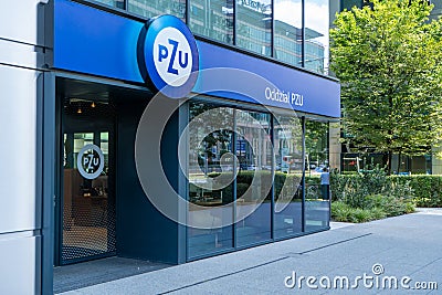 Polish insurance company PZU. Blue logo at the entrance of the building. Sign inscription over the office. Poland Editorial Stock Photo