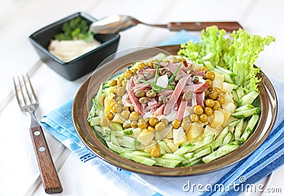 Polish salad with potatoes, ham, cucumber, green peas, capers an Stock Photo