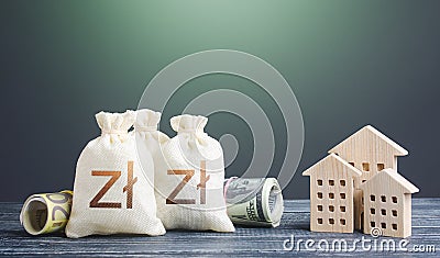 Polish zloty money bags and residential buildings figures. Financing the construction of new settlements. ortgage loan. Taxes. Stock Photo