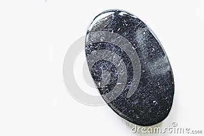 Polished black tourmaline gemstone on a white background Stock Photo