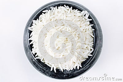 Polished long rice basmati in a stone bowl top view isolated Stock Photo