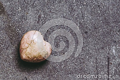 Rhodochrosite stone heart on black background Stock Photo