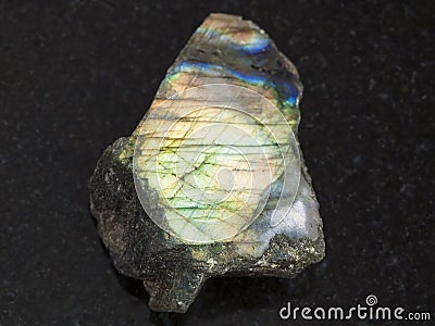 polished slab of labradorite stone on dark Stock Photo