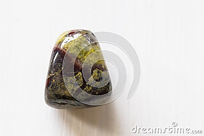 Polished tumbled stone heliotrope jasper or dragon`s blood stone on a white background Stock Photo