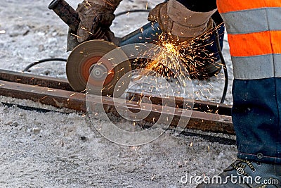 Worker polishing a tram rail Stock Photo