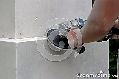 A man polishing the base of a statue Stock Photo