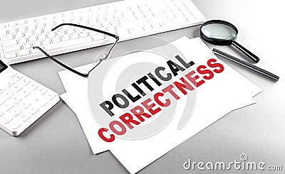 POLITICAL CORRECTNESS text on a paper on a gray background near a calculator and a white keyboard Stock Photo