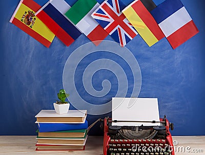 Political, news and education concept - red typewriter, flags of Spain, France, Great Britain and other countries, books Stock Photo