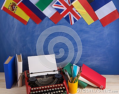 Political, news and education concept - red typewriter, flags of Spain, France, Great Britain and other countries, books, Stock Photo