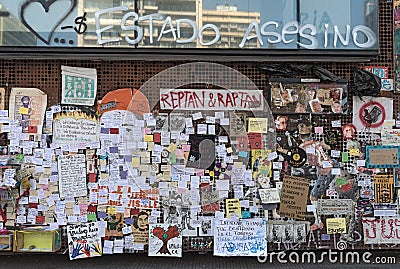 Political posters and notes of protests in Chile on a wall in Santiago, Chile Editorial Stock Photo