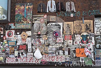 Political posters and notes of protests in Chile on a wall in Santiago, Chile Editorial Stock Photo