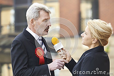 Politician Being Interviewed By Journalist During Election Stock Photo