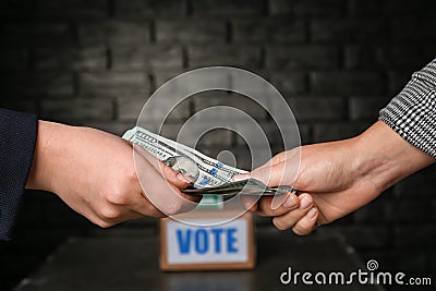 Politician taking bribe from woman on dark background. Corruption concept Stock Photo