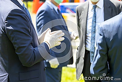 Politicians or businessmen talking at meeting wearing protective gloves and masks during coronavirus COVID-19 pandemic Stock Photo