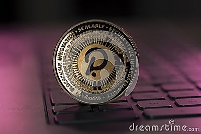 Polkadot Dot crypto coin placed on keyboard in dark background Editorial Stock Photo