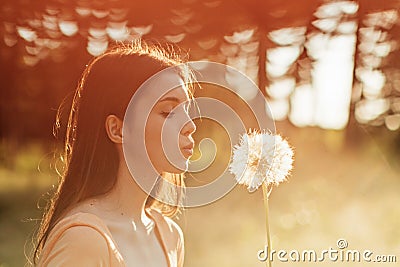 Pollen season. Summer allergies are caused by pollen from grass and Flowers. Young woman smells the blooming Flowers Stock Photo