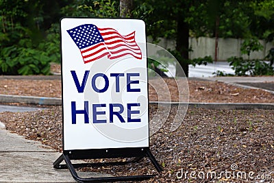 Polling place sign encouraging citizens to vote here at the local school. Stock Photo