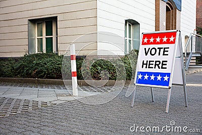 Polling Place Vote Here Sign On Board Stock Photo