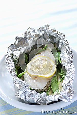 Pollock and lemon cooked in aluminium foil Stock Photo