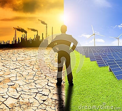 pollution and clean energy concept. businessman watching windmills solar panels and refinery with air pollution Stock Photo