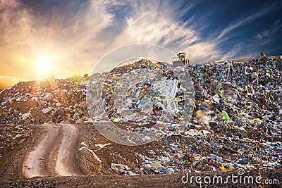 Pollution concept. Garbage pile in trash dump or landfill at sunset Stock Photo