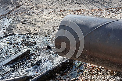 Discharge of toxic or contaminated water into a river or lake. Stock Photo