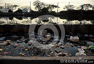Pollution river from litter at Ho Chi Minh city, Viet Nam, trash from plastic bag, bottle, packaging in water Stock Photo
