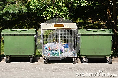 Pollution from trash plastic waste garbage. Dumpsters being full with garbage in city Stock Photo