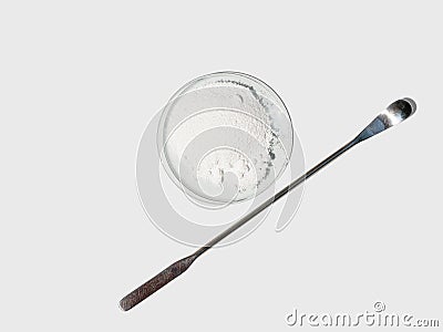 Polyacrylic acid powder in chemical watch glass placed next to the stirring rod Stock Photo