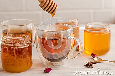 Polyfloral honey flows from a wooden honey spoon Stock Photo