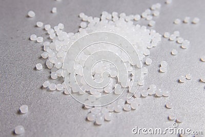 Polypropylene transparent granules on the grey background Stock Photo