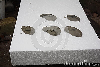 Polystyrene foam board external wall insulation. Applying adhesive on the rigid polystyrene insulation to install rigid foam Stock Photo