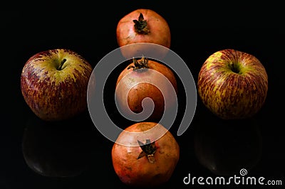 Pomegranate with apple pieces fruits on black backgrounds Stock Photo