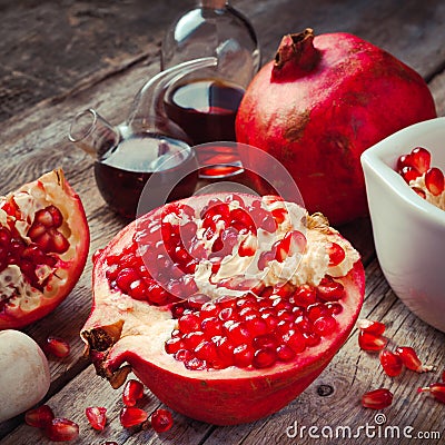 Pomegranate and bottles of essence or tincture Stock Photo